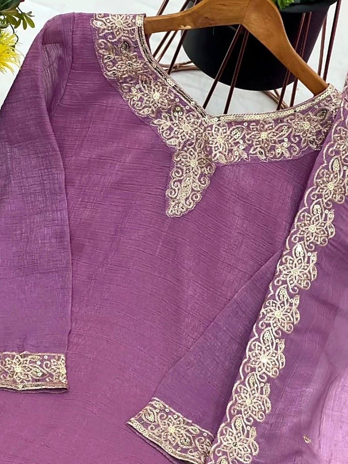 Lilac fabric with a gold embroidered neckline