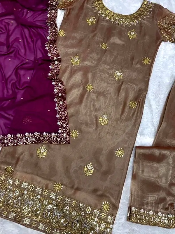 Antique gold tissue kurta with zari embroidery and a magenta dupatta, laid flat