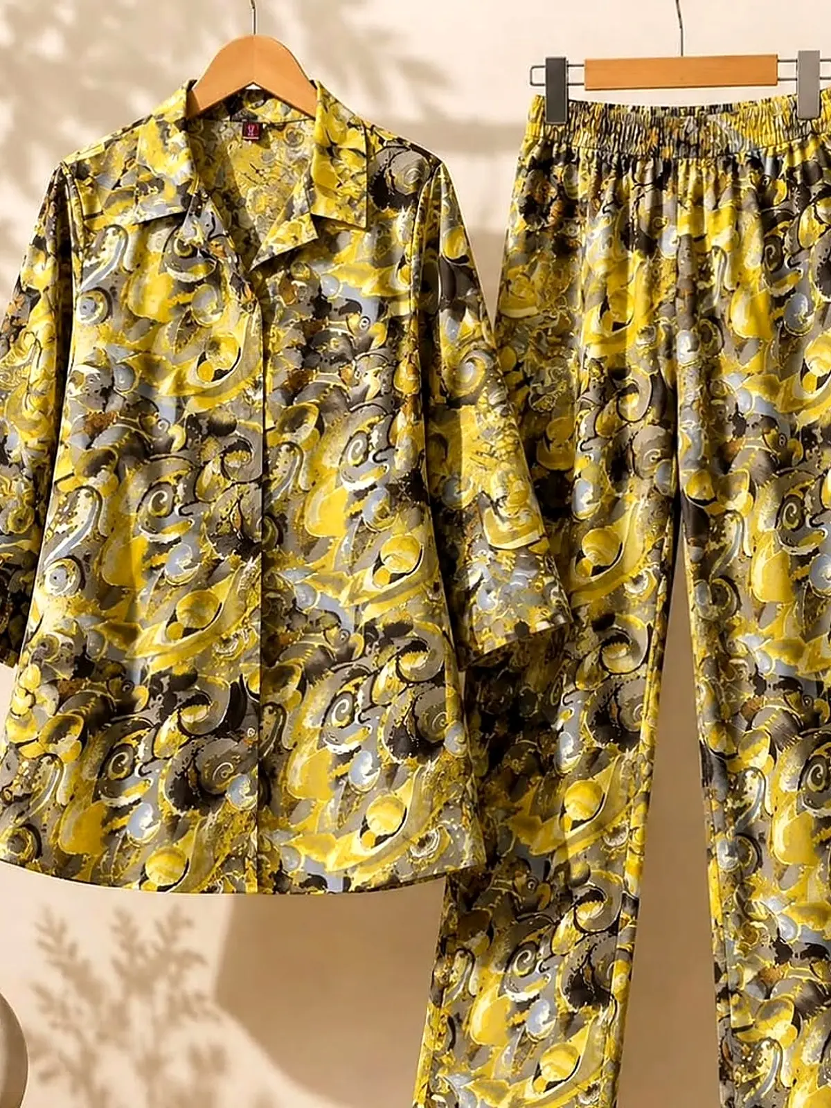 Yellow and grey swirl print cord set on wooden hangers