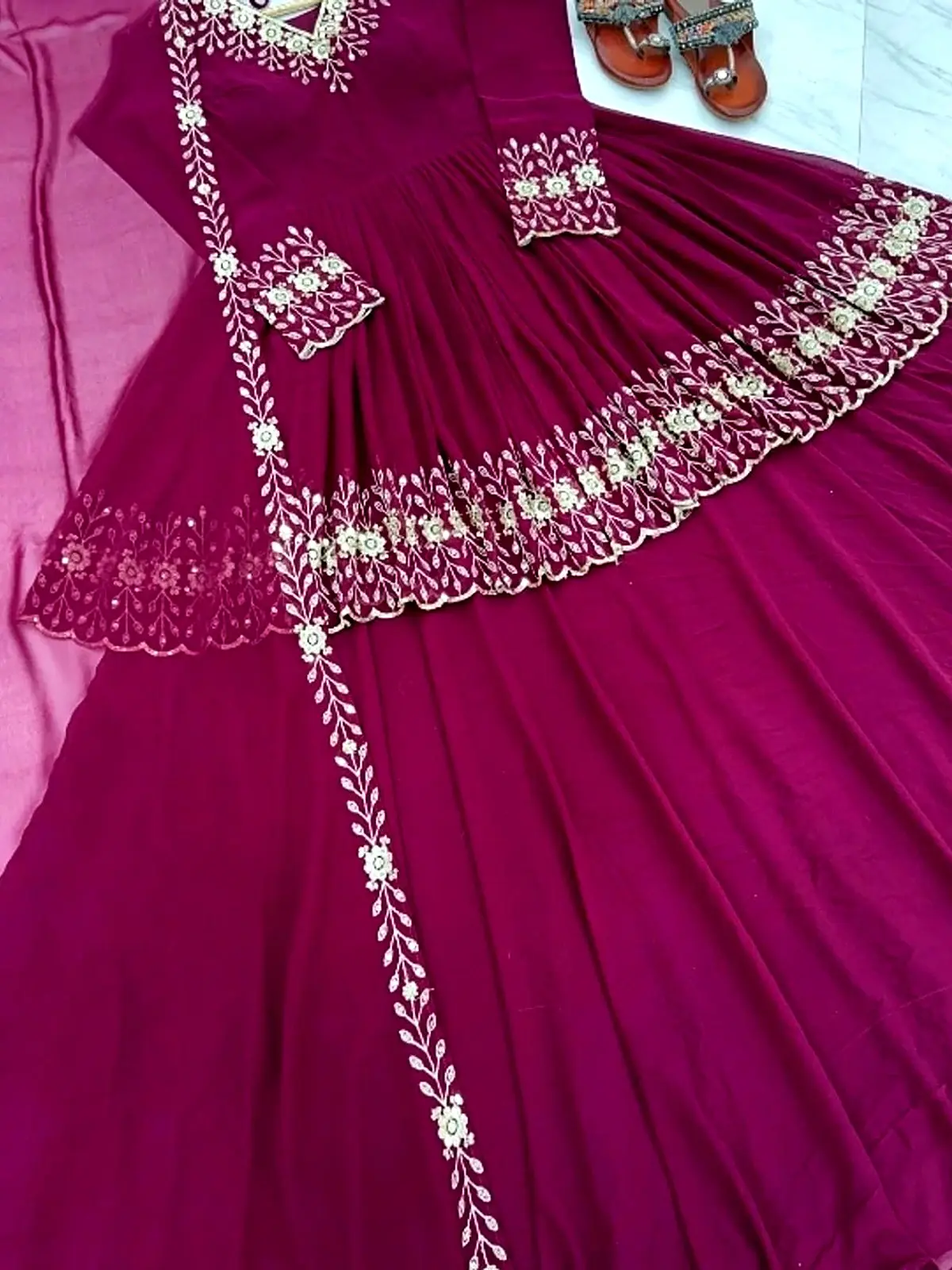 Magenta flared anarkali maxi with cream embroidered border, laid flat