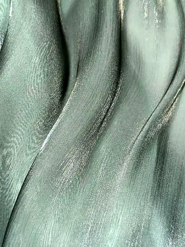 Close view of mint green shimmer georgette fabric in soft folds
