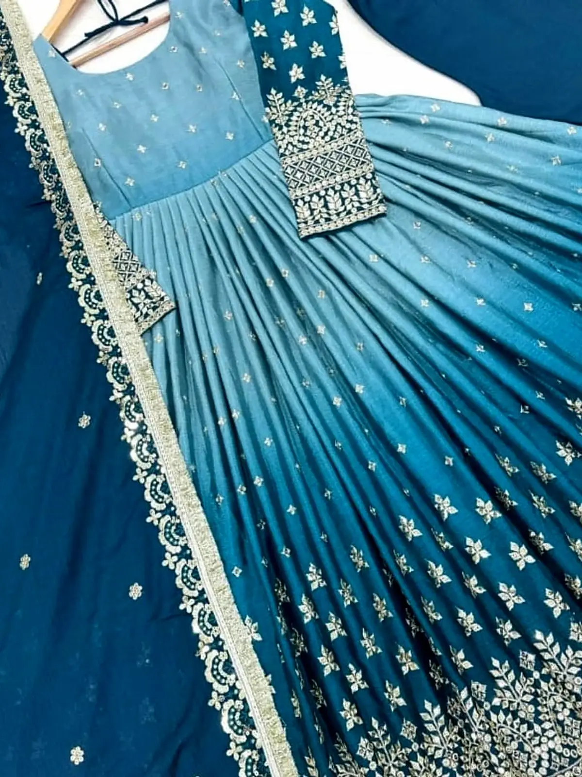 Teal to sky-blue ombré anarkali maxi with silver embroidery, laid flat